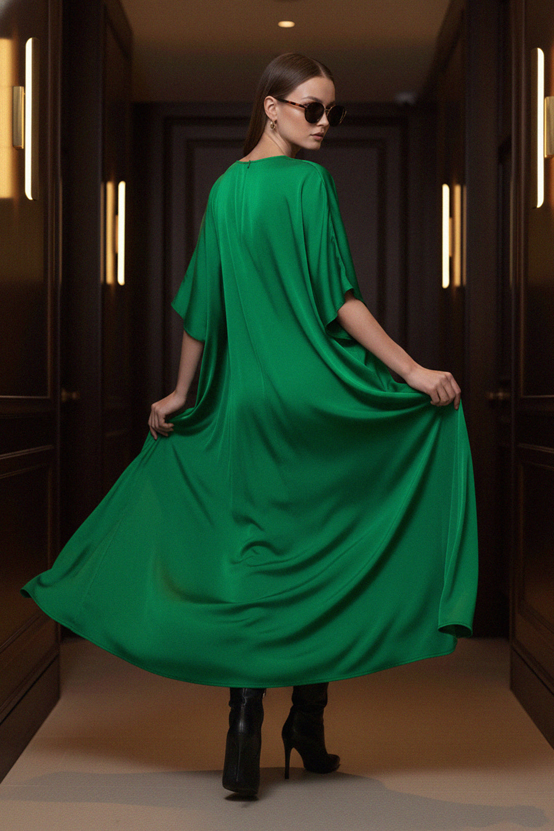 trendy-green-dress, back-pose, Shahida-Parides, vacation-style, silk-kaftan, side-slit, luxury-outfit, black-boots, fashion-forward, elegant-dress, modern-outfit, chic-style, relaxed-look
