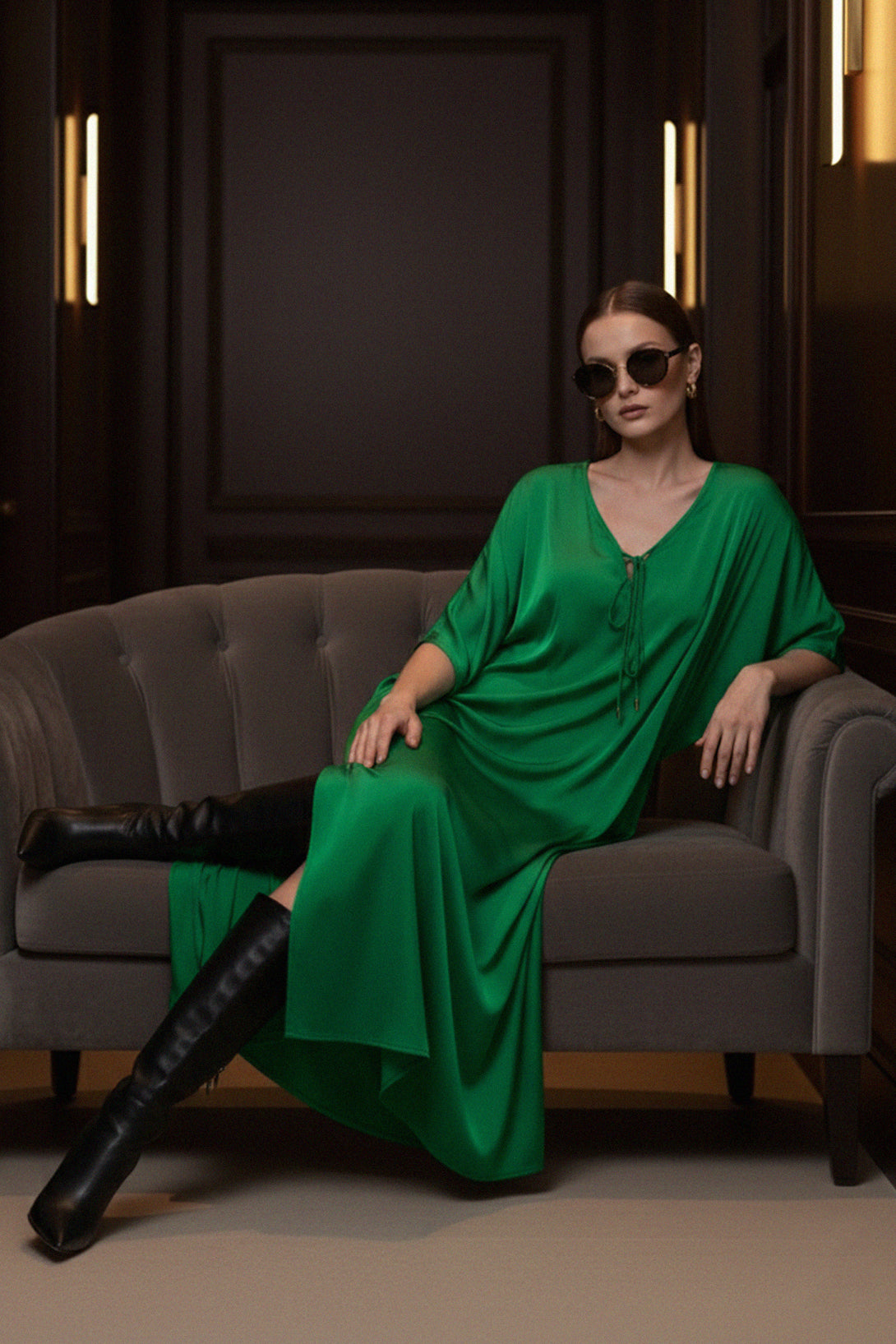 fashion-model, green-silk-dress, sitting-pose, Shahida-Parides, luxury-sofa, vacation-vibes, chic-look, elegant-kaftan, stylish-outfit, modern-dress, resort-style, green-fashion, relaxed-elegance