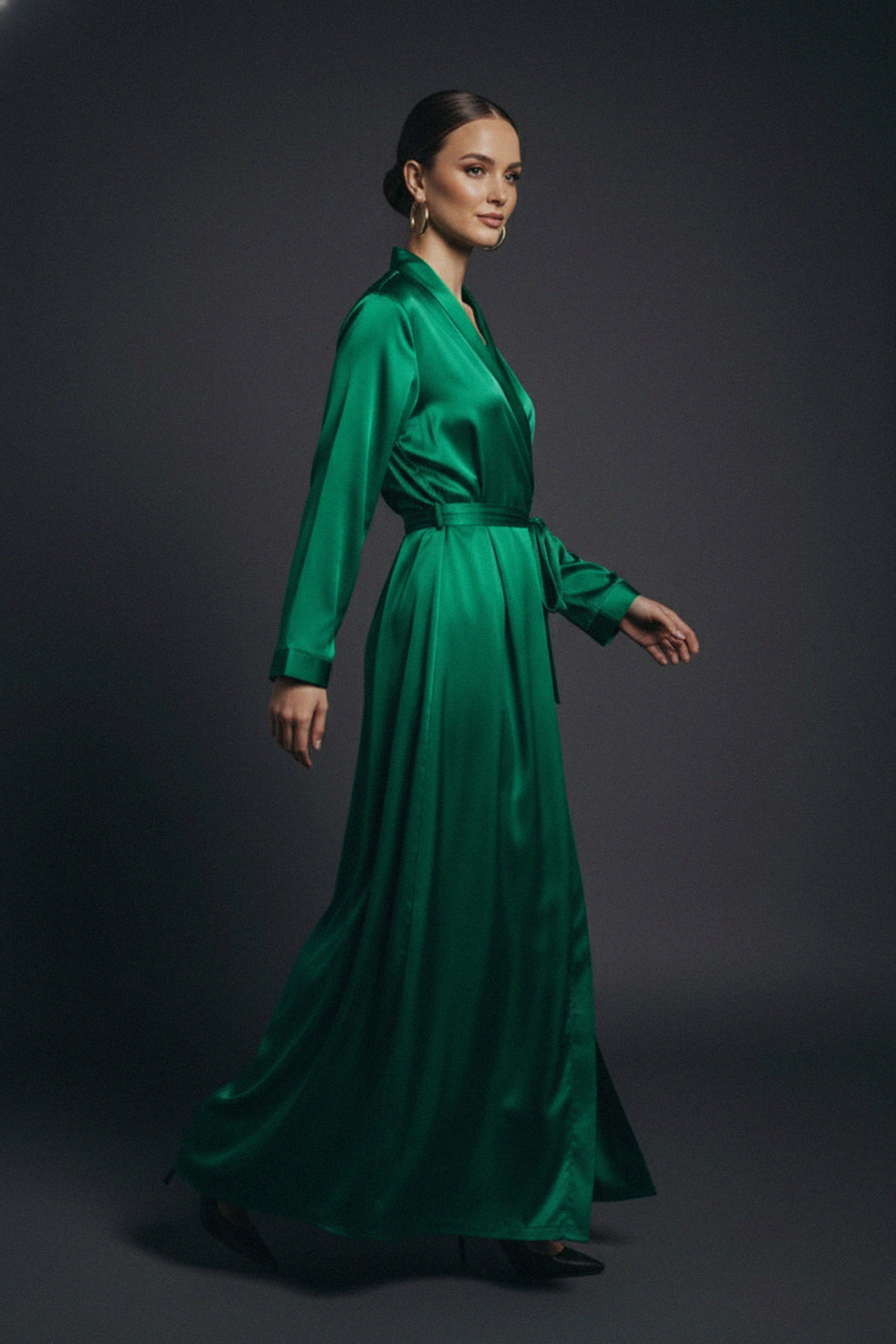 emerald wrap gown, satin maxi dress, right side view, Shahida Parides, green evening gown, belted silk dress, elegant silhouette, luxury style, women’s wear, satin fashion, classy outfit, event attire