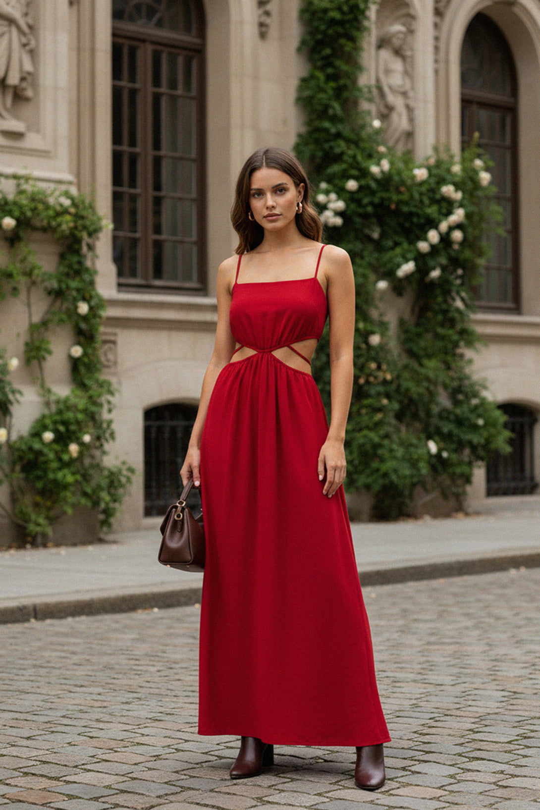 Elegant red maxi dress with side cutouts and spaghetti straps, perfect for evening wear or summer occasions.