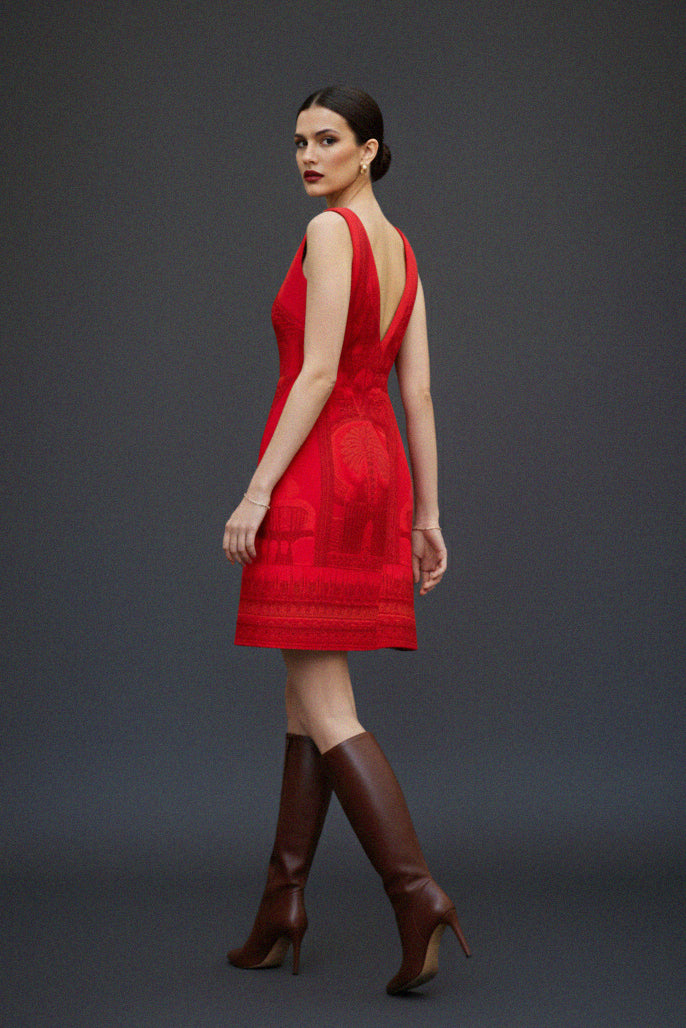 Shahida Parides red dress woman backless V-neck designer outfit elegant fashion look brown leather boots fall winter style