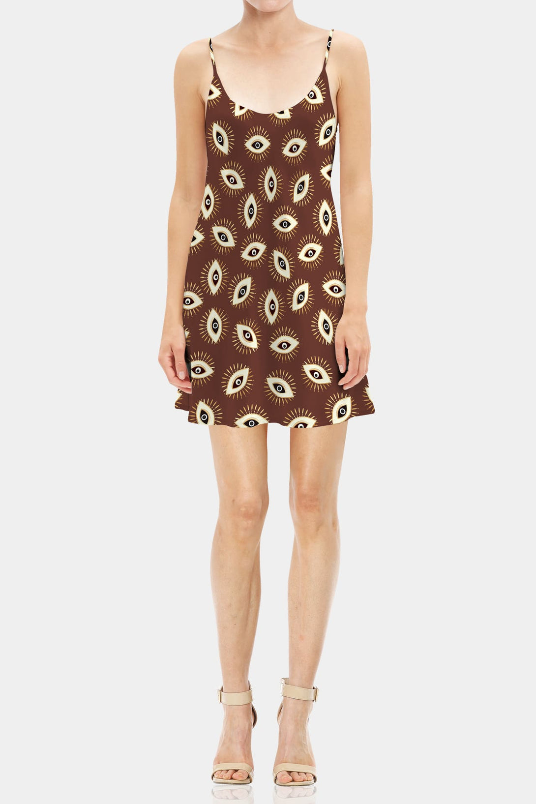 Brown eye-print mini dress styled with a maroon leather jacket in a dimly lit lounge setting.